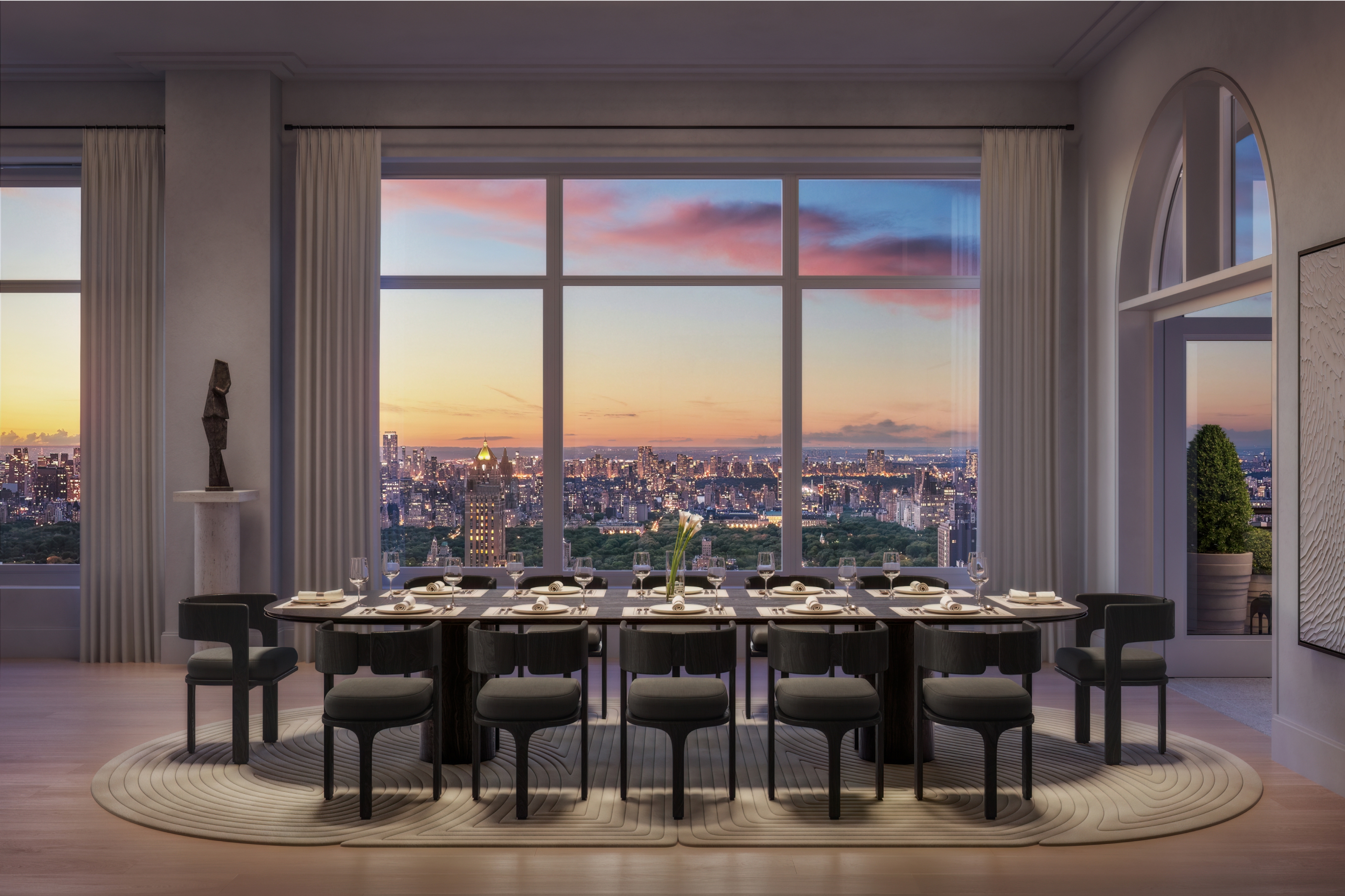 Elegant penthouse dining room featuring panoramic view of the city skyline at sunset, at 255 East 77th, UES new condominiums.